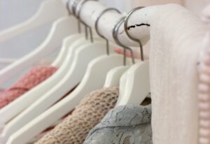 clothes hanging on white clothing rack that is about to break