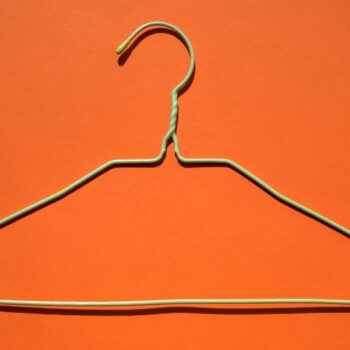 wire hanger on orange background