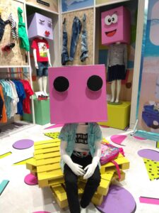 child mannequin wearing a box for a head