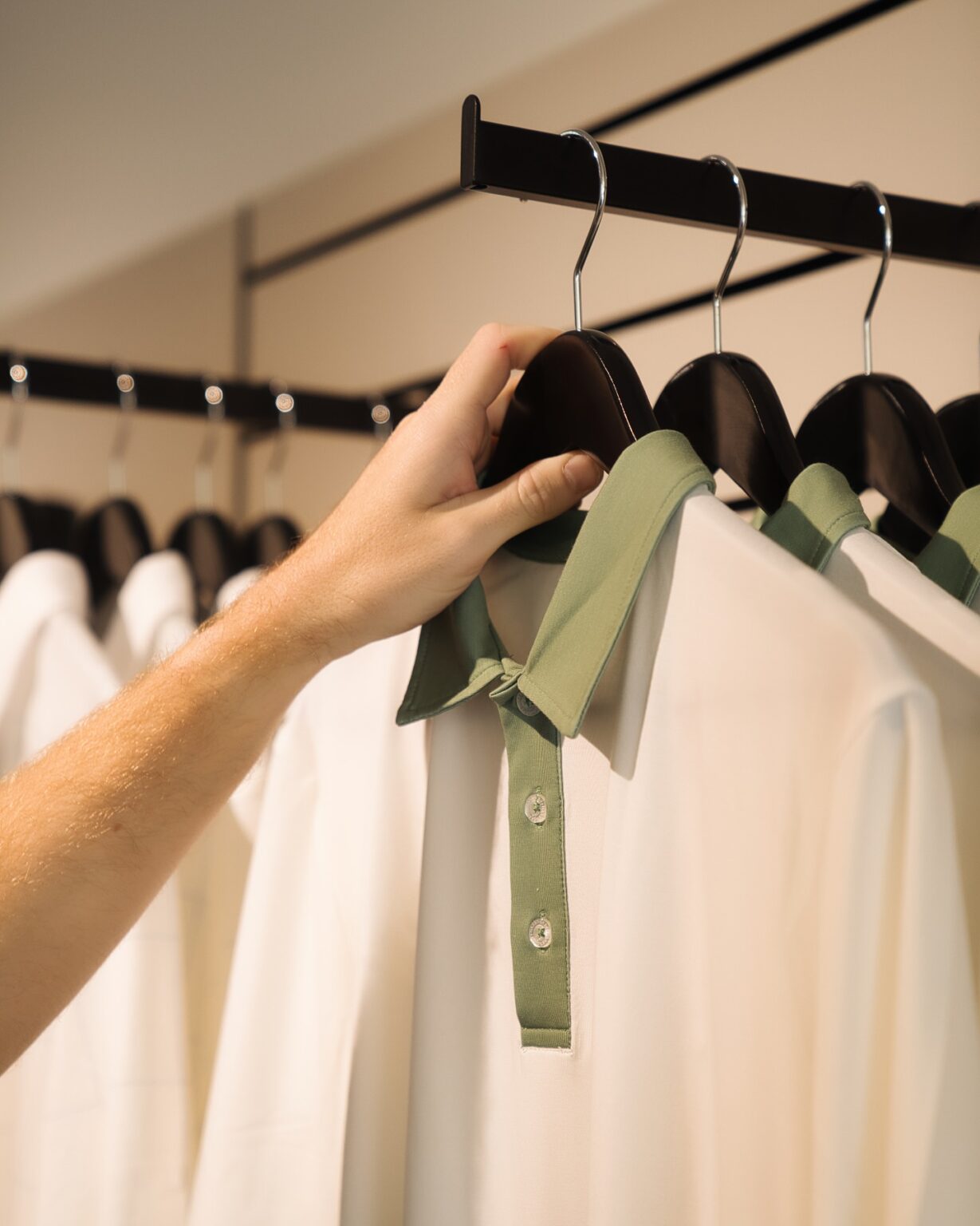 Coat hangers on straight arm in golf store