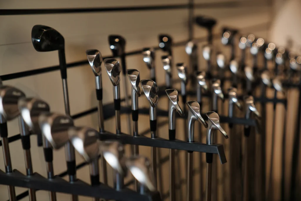 Golf clubs on slatwall display within Noosa Golf Co