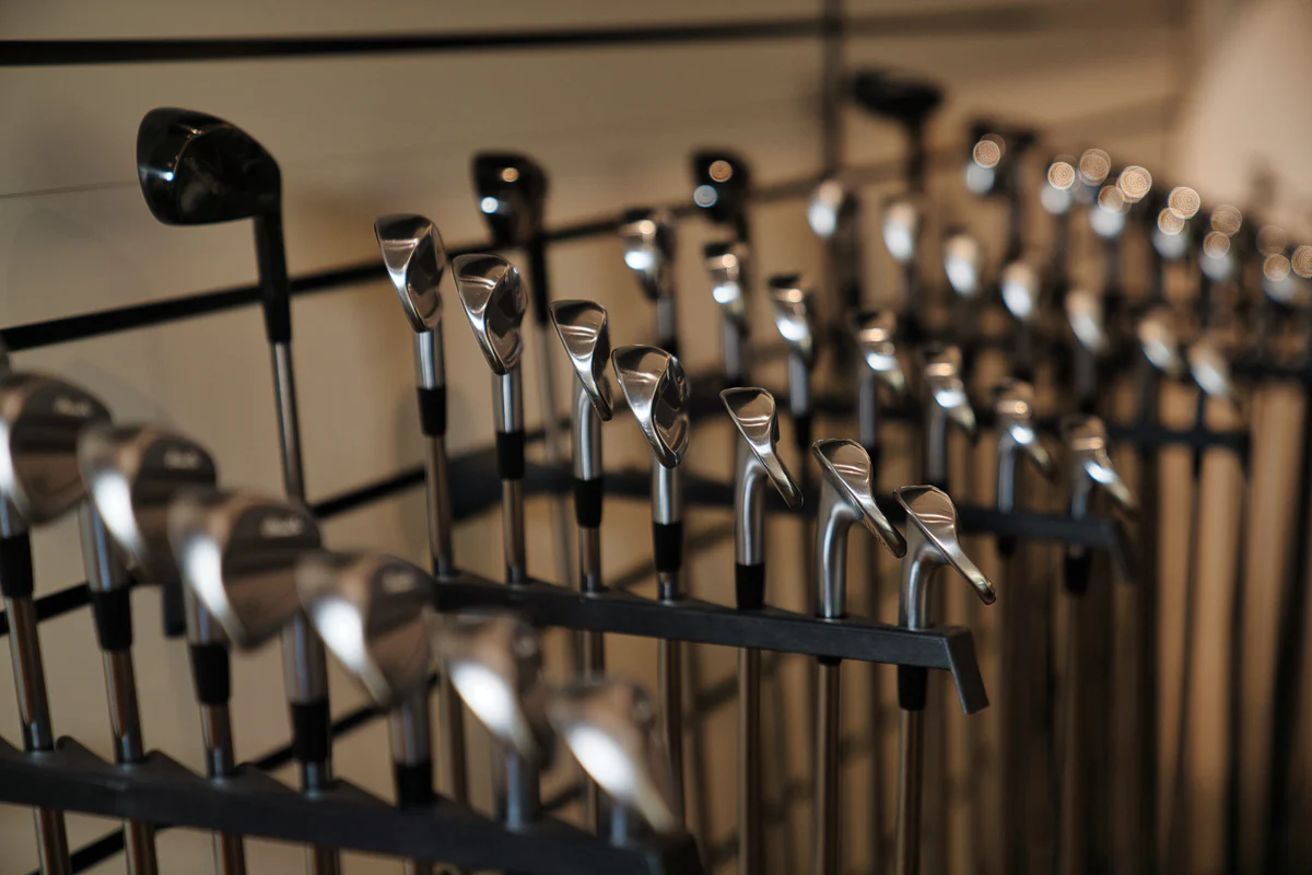 Golf clubs on slatwall display within Noosa Golf Co